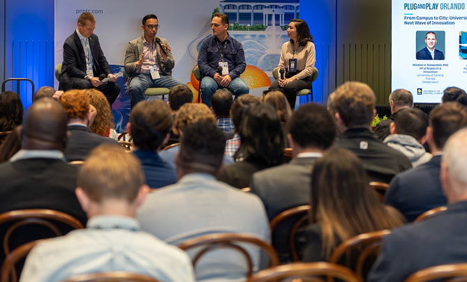 Actualization AI on a panel discussion in front of a full room